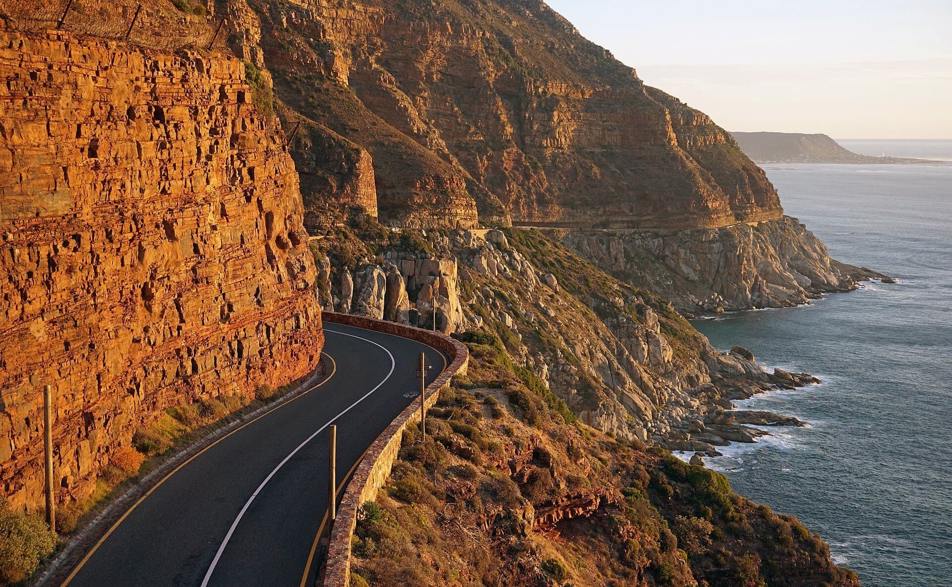 Chapman's Peak Drive carved into golden cliffs above the sea