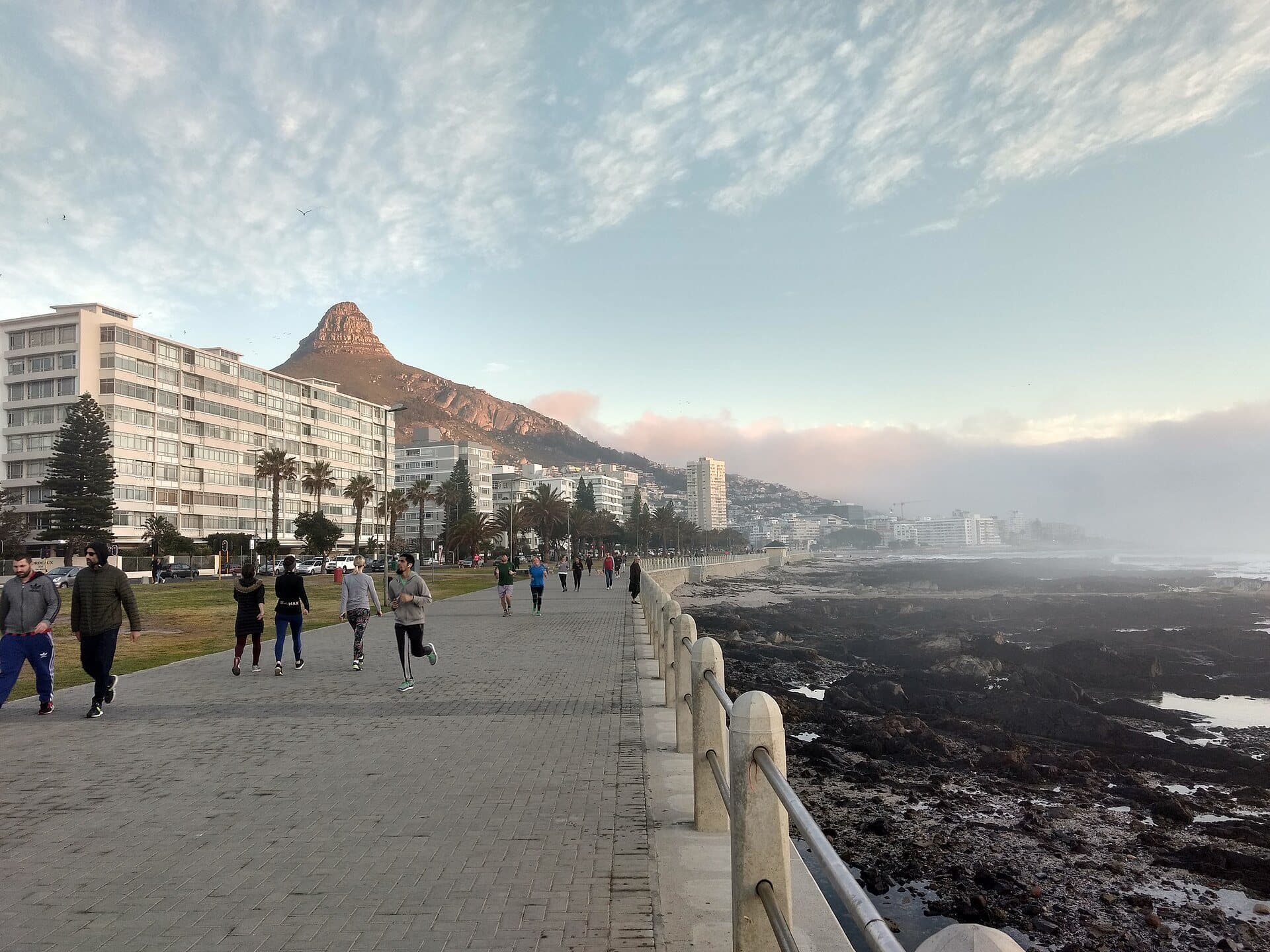 Walkers on the Sea Point promenade, with Lion's Head behind